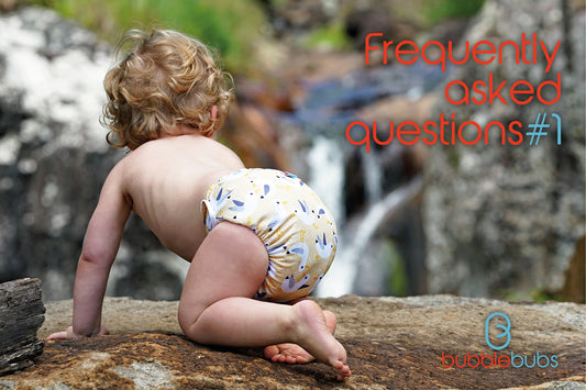 Toddler-crawling-on-a-rock-wearing-a-yellow-reusable-cloth-nappy-in-Australia