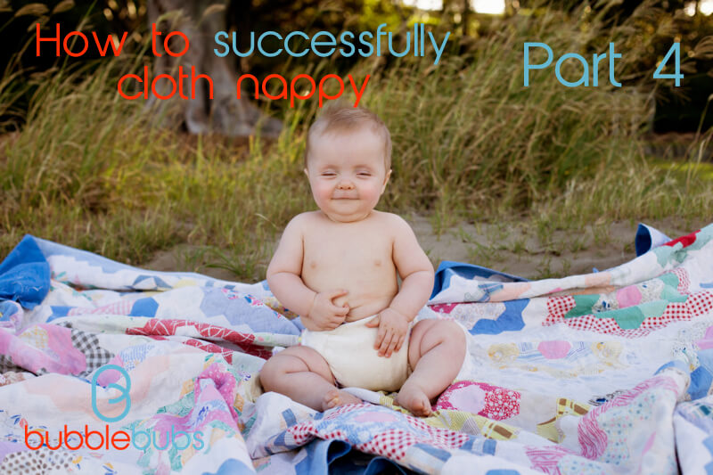Baby sitting on the beach with cloth nappy