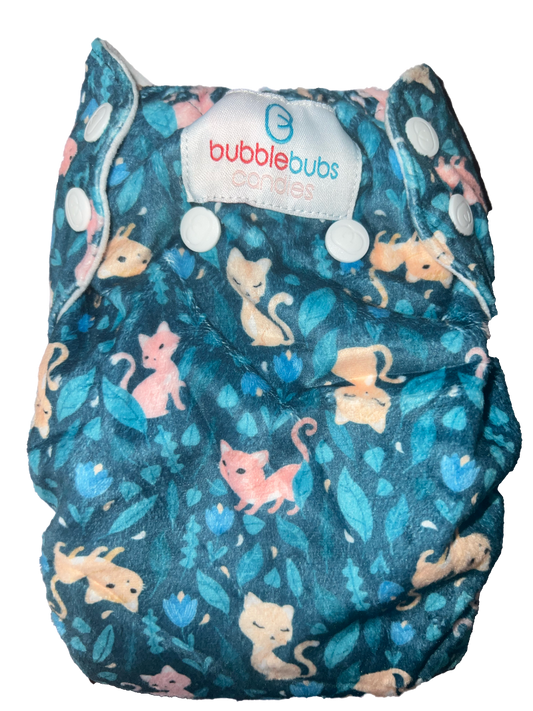 cats and flowers on the back of a candie cloth nappy