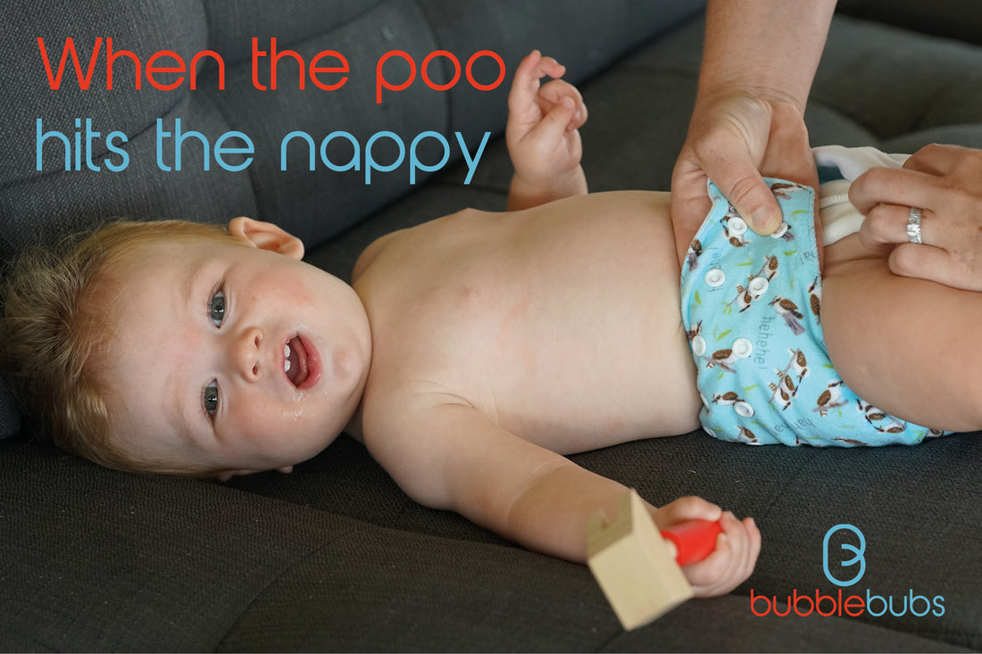 Baby-having-his-nappy-changed-on-a-couch-holding-a-toy-hammer