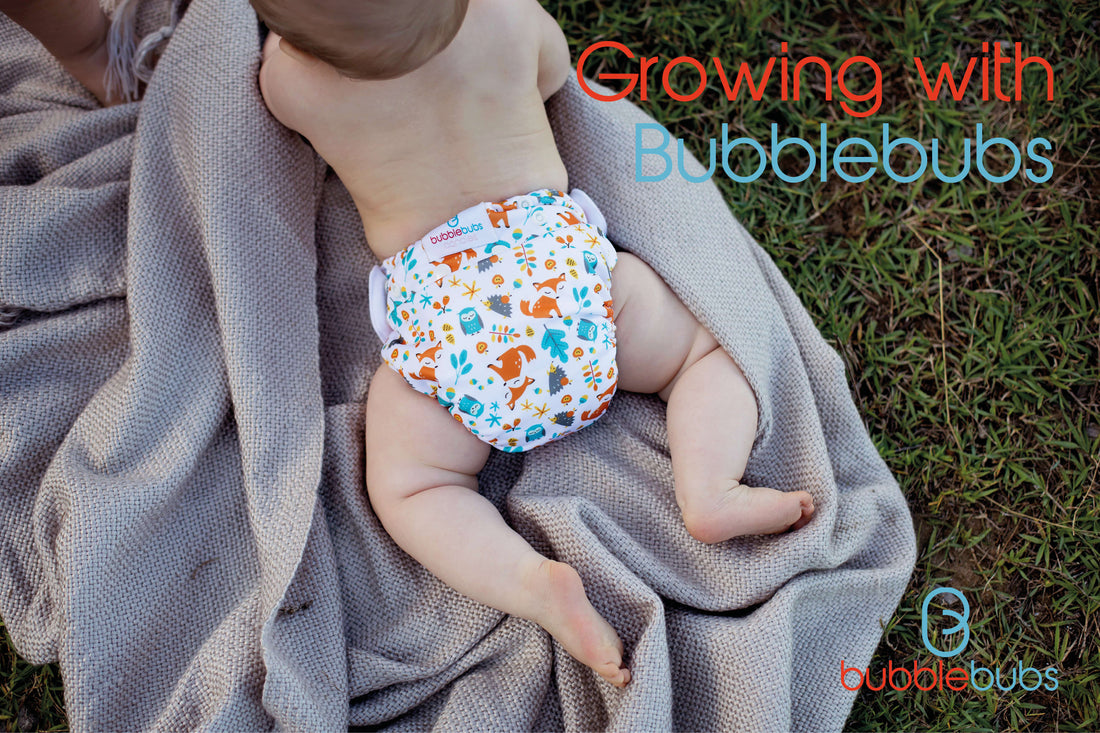Baby-laying-on-a-blanket-on-the-grass-wearing-a-modern-cloth-nappy
