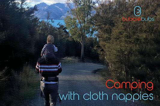 Man-walking-with-baby-on-his-shoulders-wearing-a-cloth-nappy-in-New-Zealand