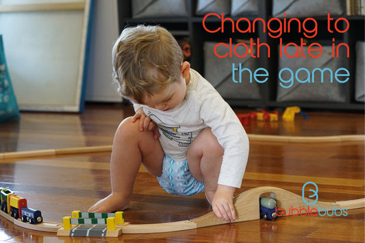 Toddler-wearing-a-modern-cloth-nappies-while-playing-with-a-train-set
