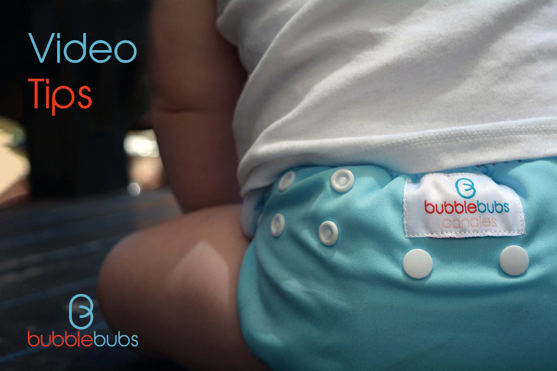 baby-sitting-wearing-a-pale-blue-Candies-OSFM-AI2-modern-cloth-nappy-from-Bubblebubs