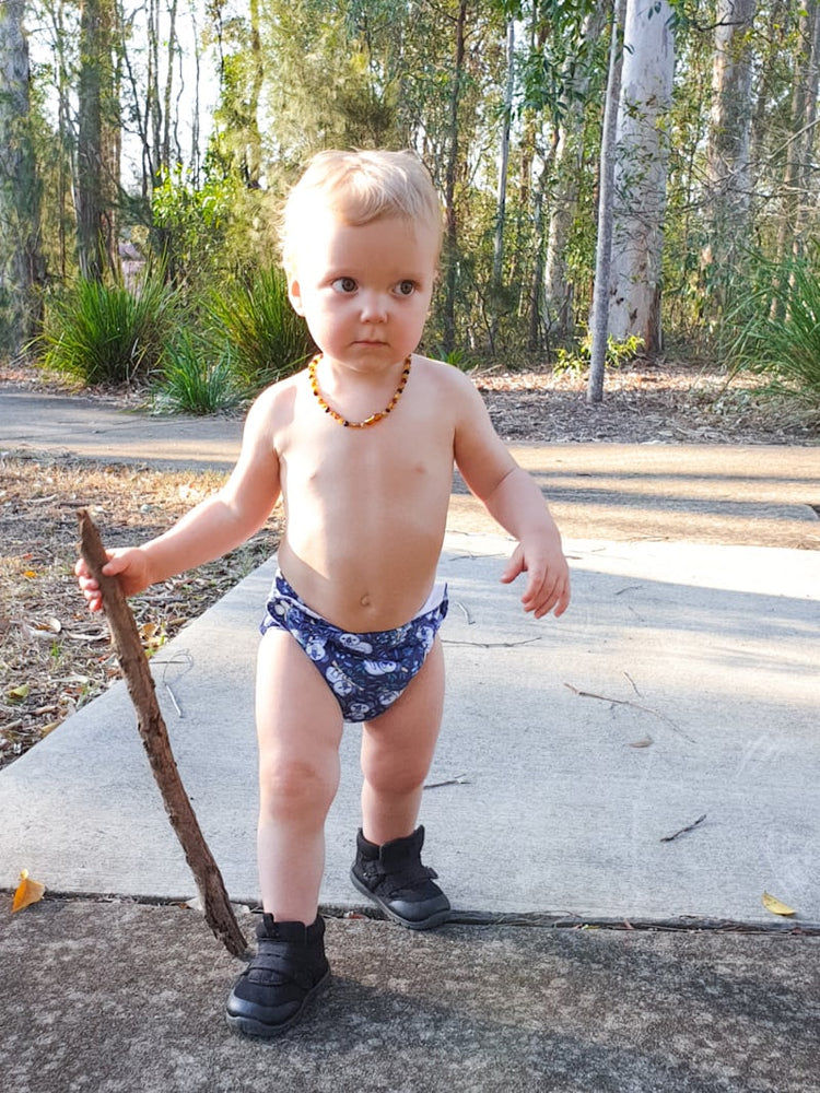 the bubblebubs candie cloth nappy does not need rise snaps. blue candie on a toddler out for a walk