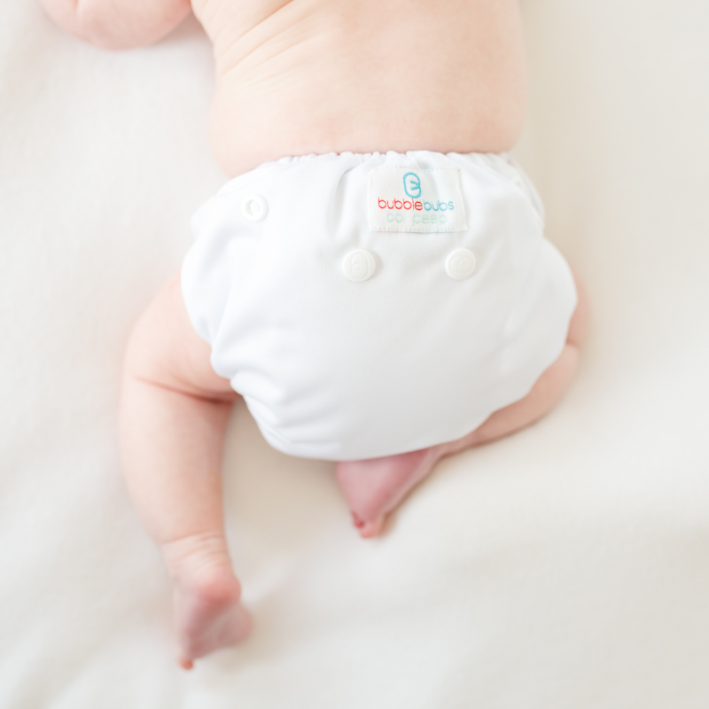 never released white bopeep newborn cloth nappy. one a newborn baby bum up on a soft white mat