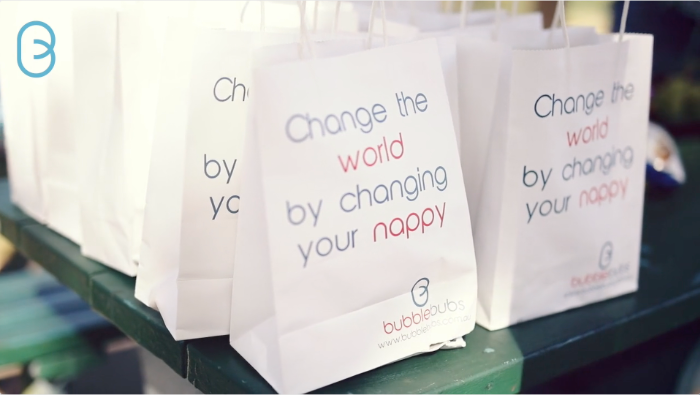 change the world by changing your cloth nappy on a white bag in the bubblebubs font