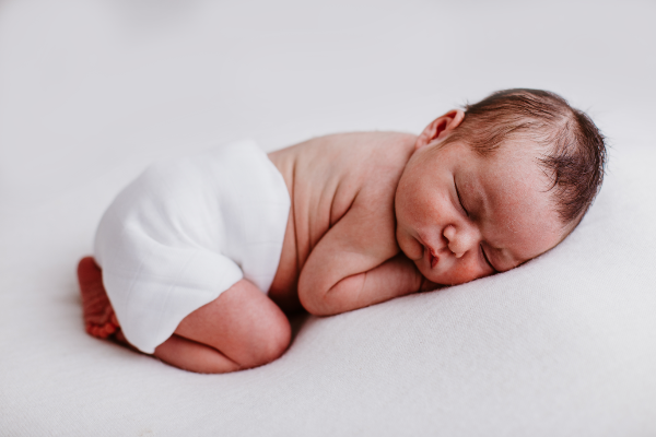 flat cloth nappy on a sleeping newborn baby