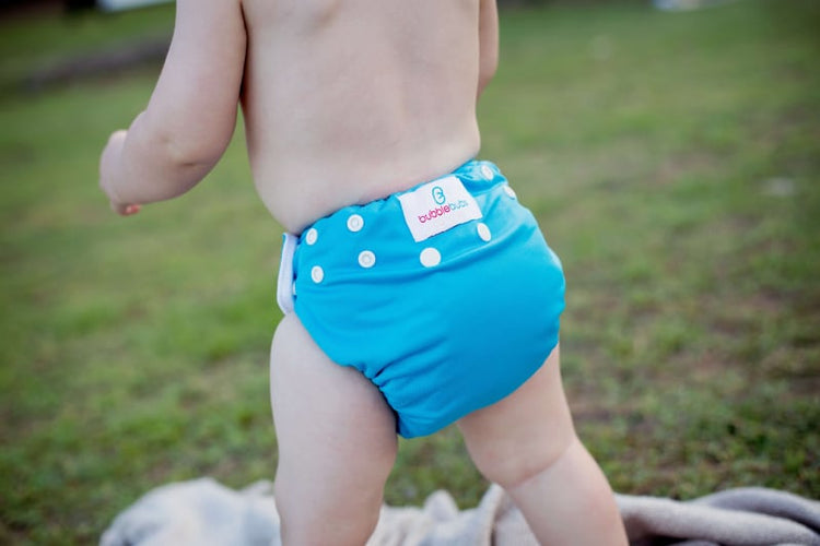 candie cloth nappy blue on a walking baby in a park Bubblebubs